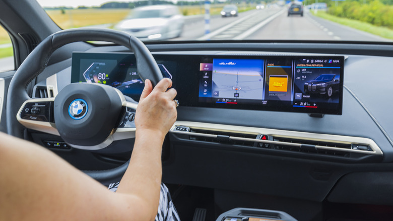 person using touchscreen in car