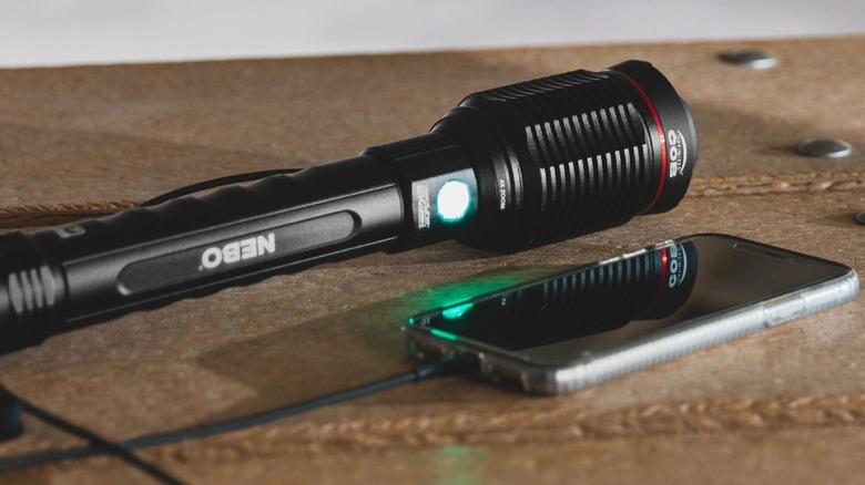 NEBO flashlight charging a phone