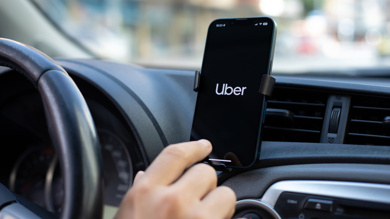 Uber app on a smartphone in a car