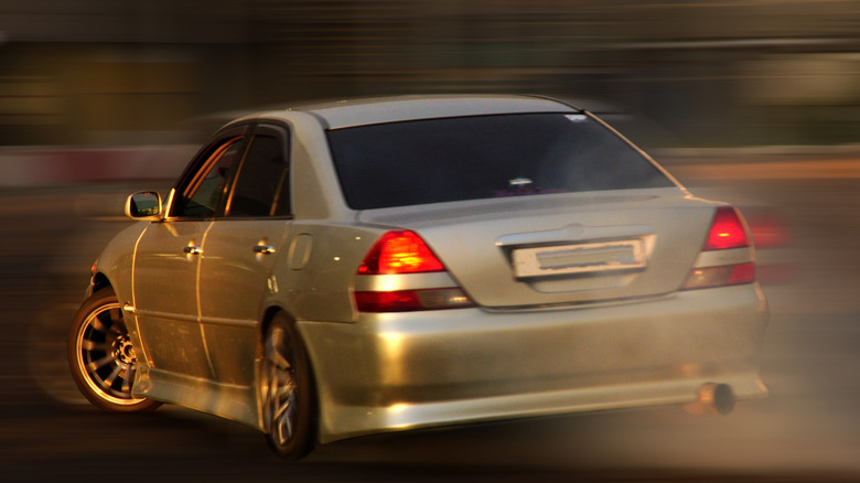 A car speeds with a blurred background.