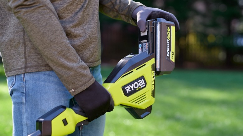 Person removing Ryobi battery