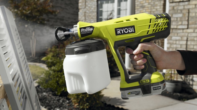 Person using Ryobi Paint Sprayer