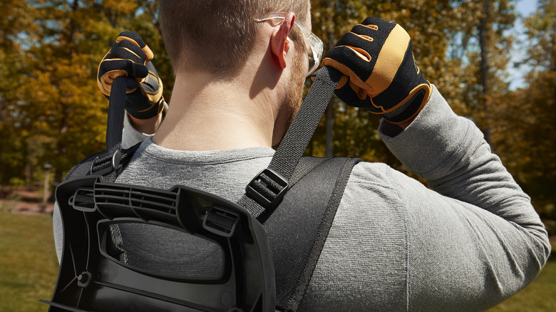 Man using Ryobi backpack leaf blower