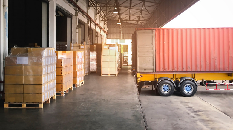 Cargo container being loaded with cardboard boxes