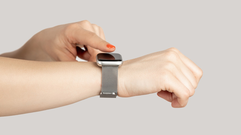 Finger touching smartwatch screen