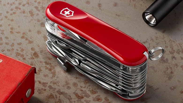 Swiss Army Knife on surface with flashlight