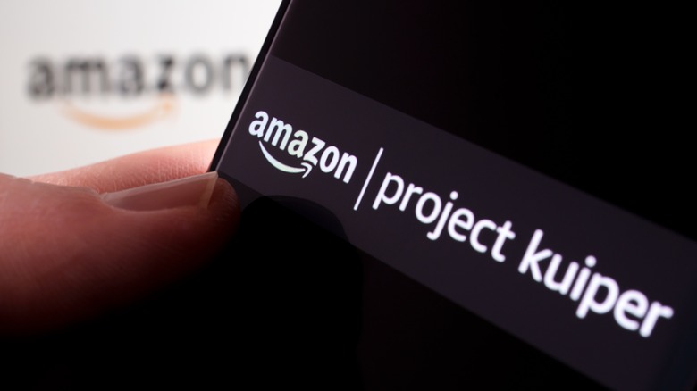 Amazon logo in the background with the Project Kuiper name on a phone screen