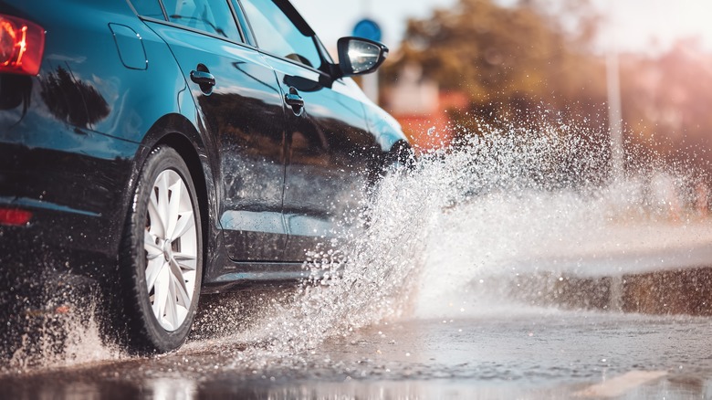 Car driving through large puddle