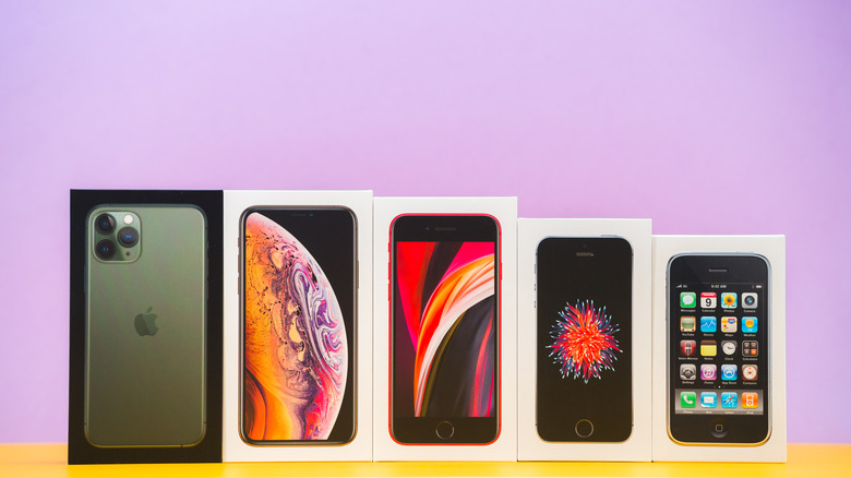 iPhone boxes throughout the years lined up on table