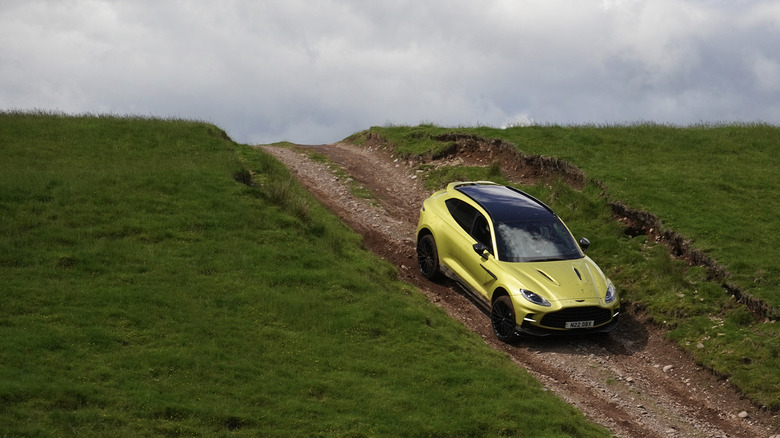 2025 Aston Martin DBX 707 descending a rocky hill