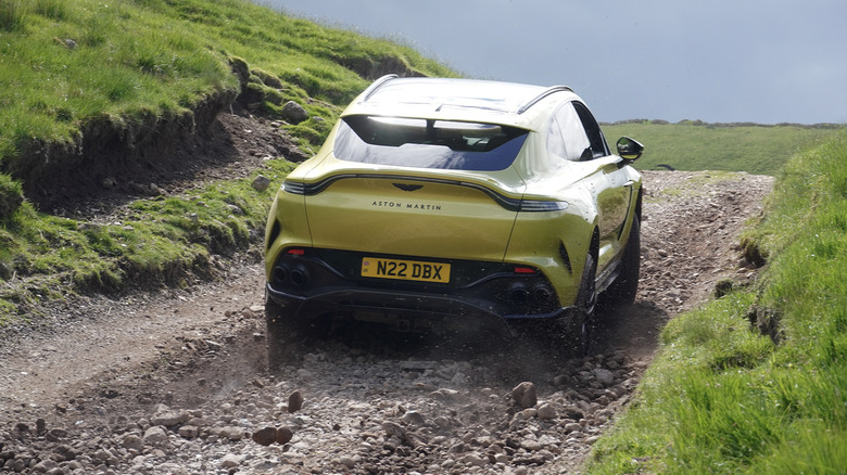 2025 Aston Martin DBX 707 climbing up a rocky road