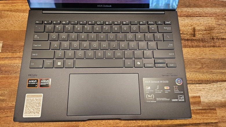 Asus Zenbook 14 OLED 2024 keyboard and touchpad on a wooden table