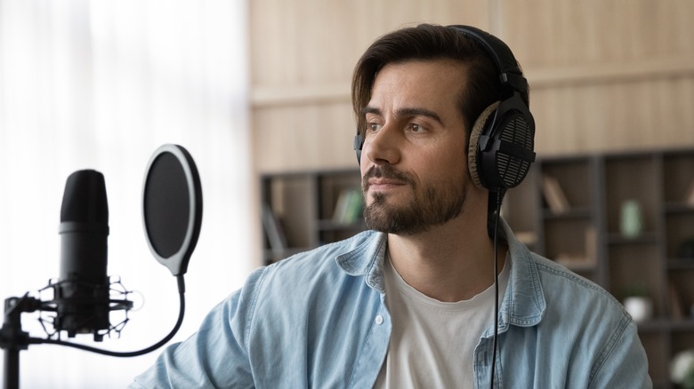 Man recording song with guitar