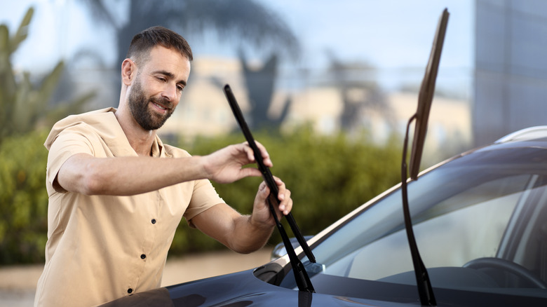 Man replacing his windshield wipers