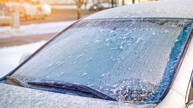 Car windshield covered in ice