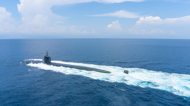 Surfaced submarine sailing through ocean