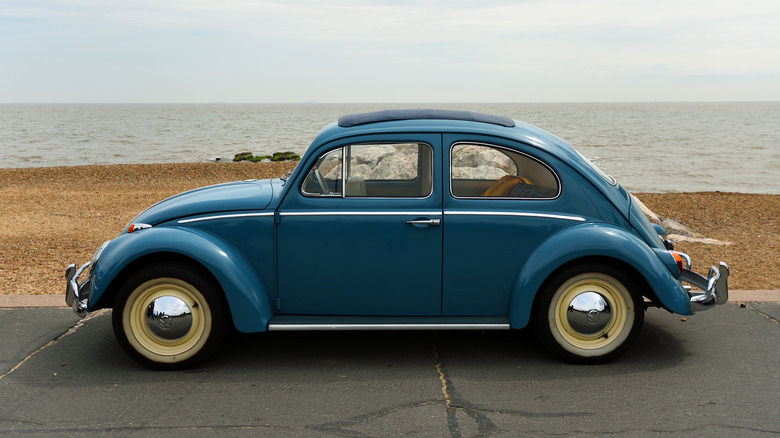 Blue Volkswagen Beetle by shore