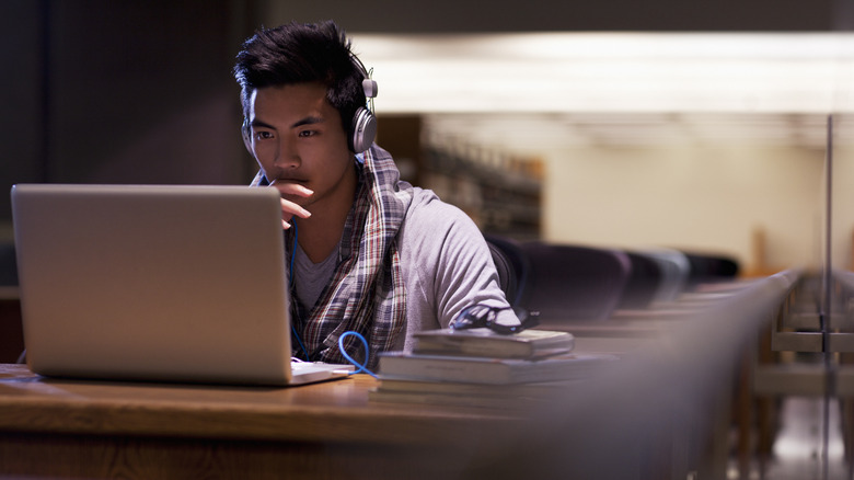 man studying with laptop