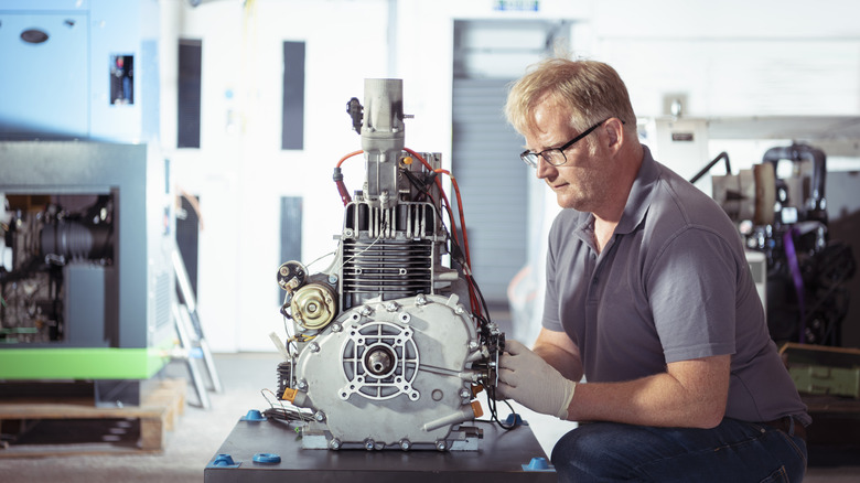 engineer with a biogas engine