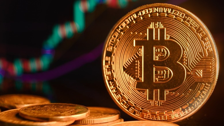 Bitcoin coins near stock ticker
