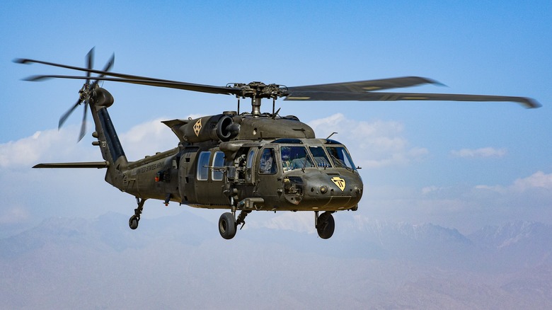 A UH-60M Black Hawk Army helicopter flying over the desert.