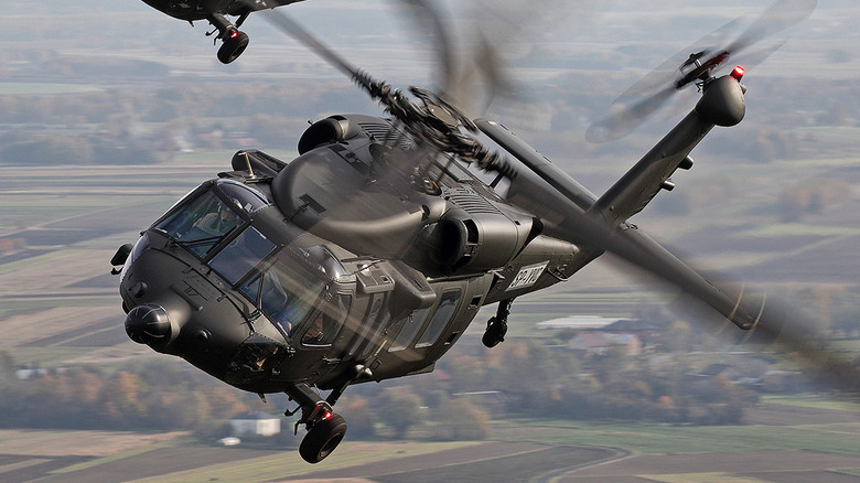 Two Sikorsky Black Hawk helicopters in the air