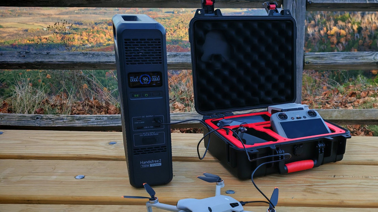 The Bluetti Handsfree 2 charging a drone on a picnic table in a state park