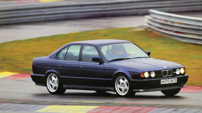 Blue BMW M5 E34 cornering fast on a track