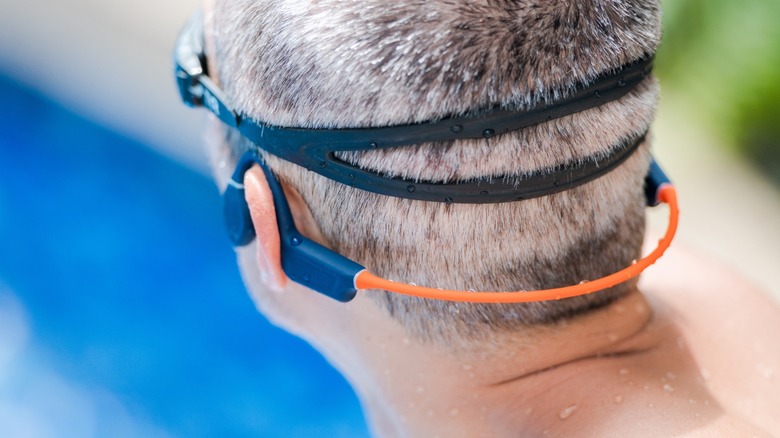 back of mans head wearing bone conduction headphones