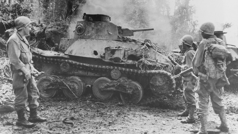 Marines standing near Type 95 Ha-Go tank