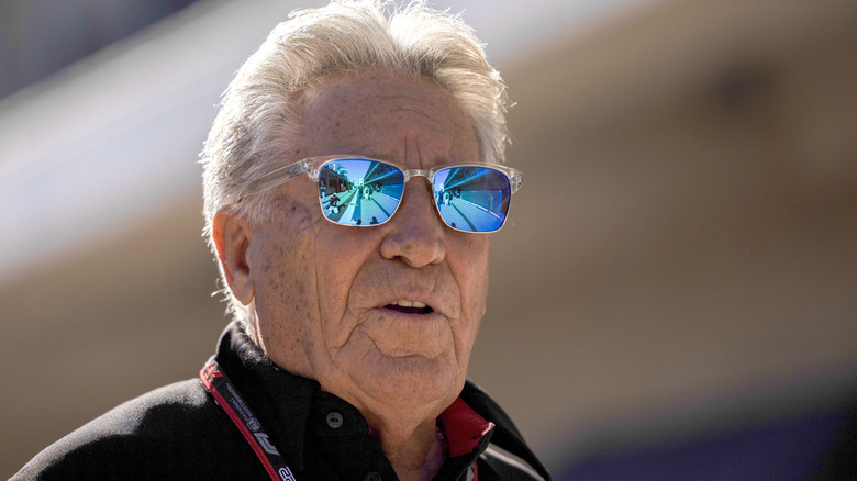 Mario Andretti wearing bright blue sunglasses