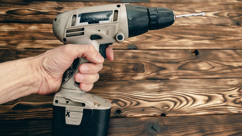 Person holding normal cordless power drill