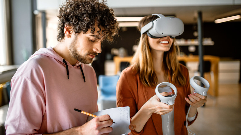 woman uses vr next to man