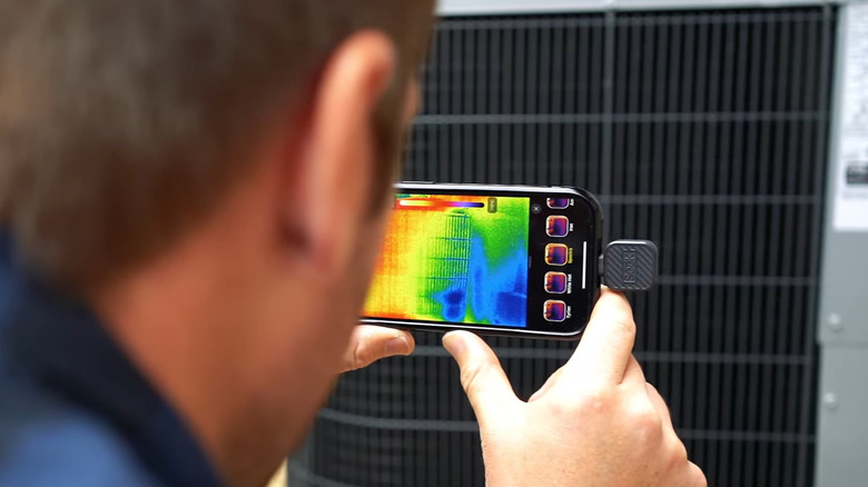 Man using phone for thermal scanning