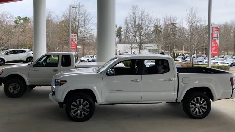 A 2020 Toyota Tacoma in front of a 1999 Tacoma with more than 500k miles