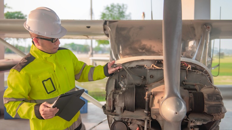 technician inspecting airplane engine