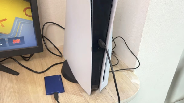 PlayStation 5 in vertical orientation with external HDD attached