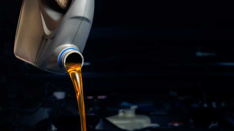 Pouring a bottle of engine oil