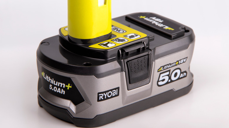 A Ryobi battery on a white surface.