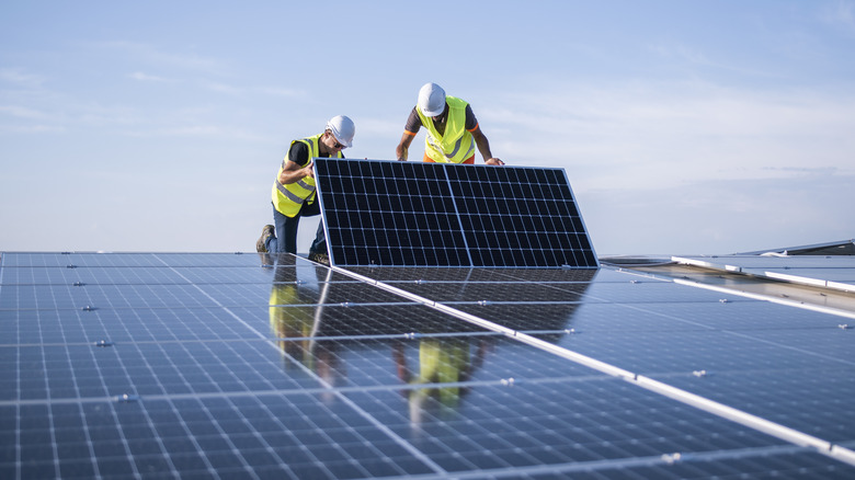 engineers installing roof solar panels