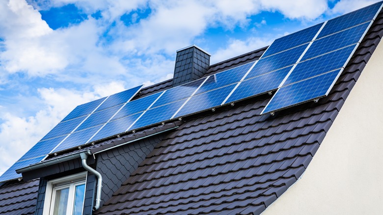 House with photovoltaic photo solar panels on roof