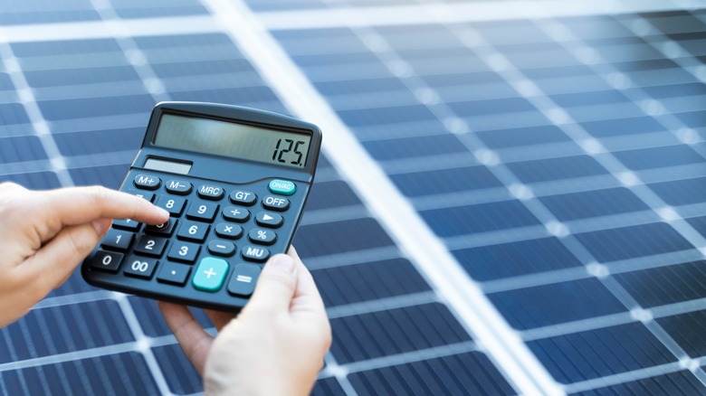 Calculator and solar panels on roof