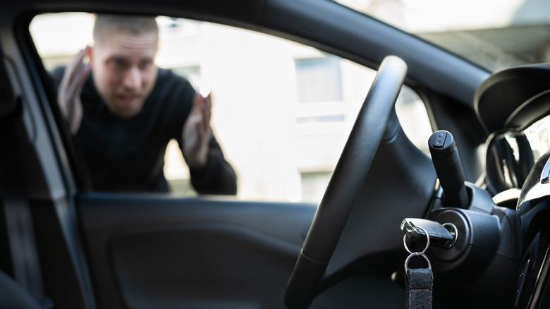 man peering in car