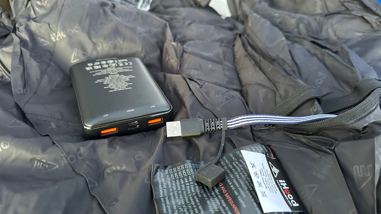 Battery pack and cable attached to heated vest