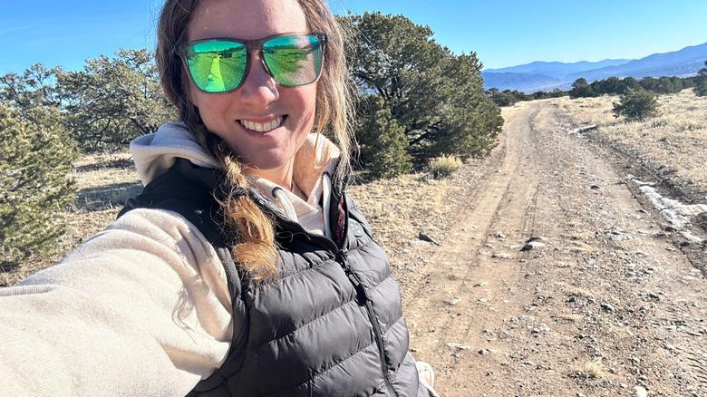 Girl outside taking a selfie while wearing heated vest