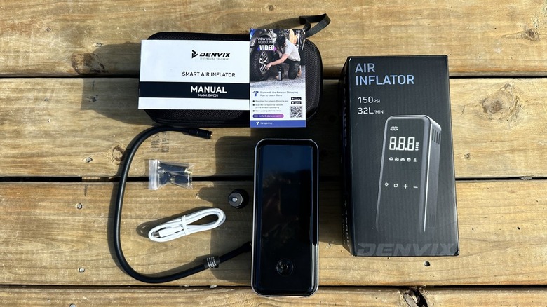 Air inflator and accessories unboxed on planks of wood