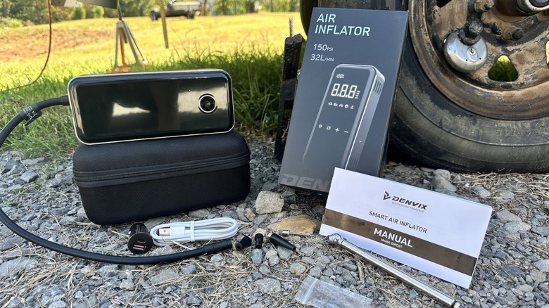 Portable air inflator and accessories displayed on the ground