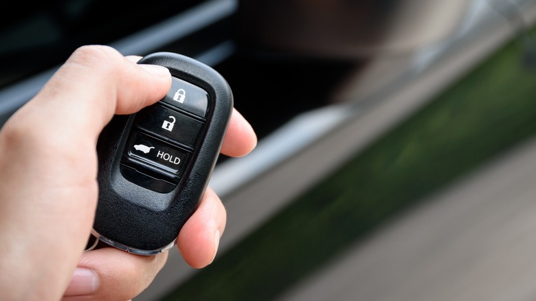 Person Holding A Remote Keyless Entry Fob