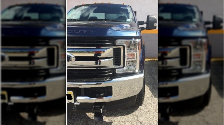 A Ford Superduty with snowplow mount attached.