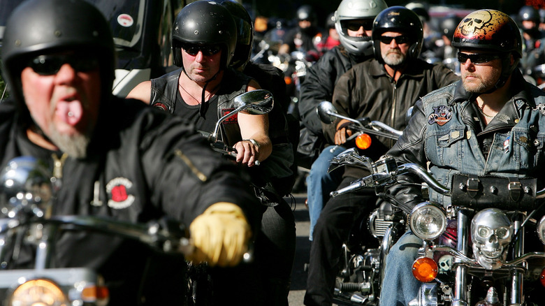 Members of a motorcycle gang ride together.